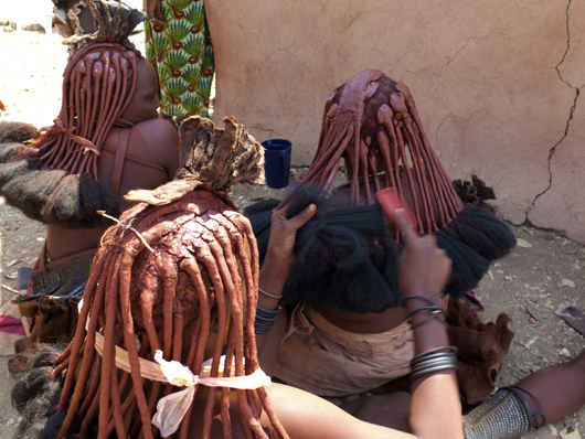 髪の毛の先に付けた羊の毛を梳かすヒンバ族の女性